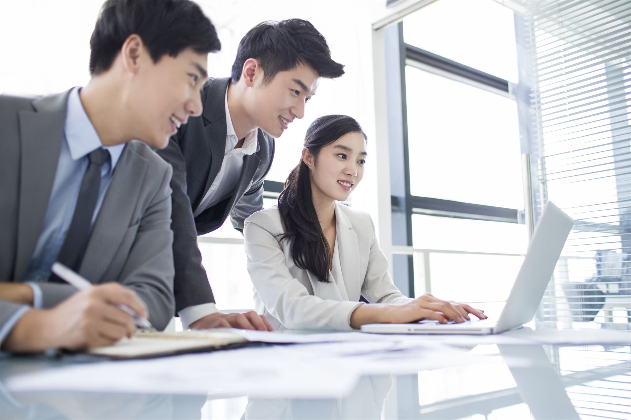Business team analyzing sales data on laptop
